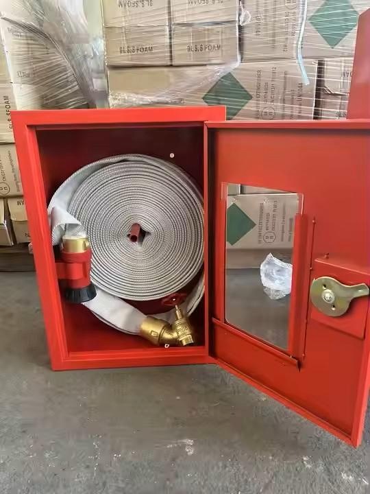 Open fire hose cabinet with coiled hose